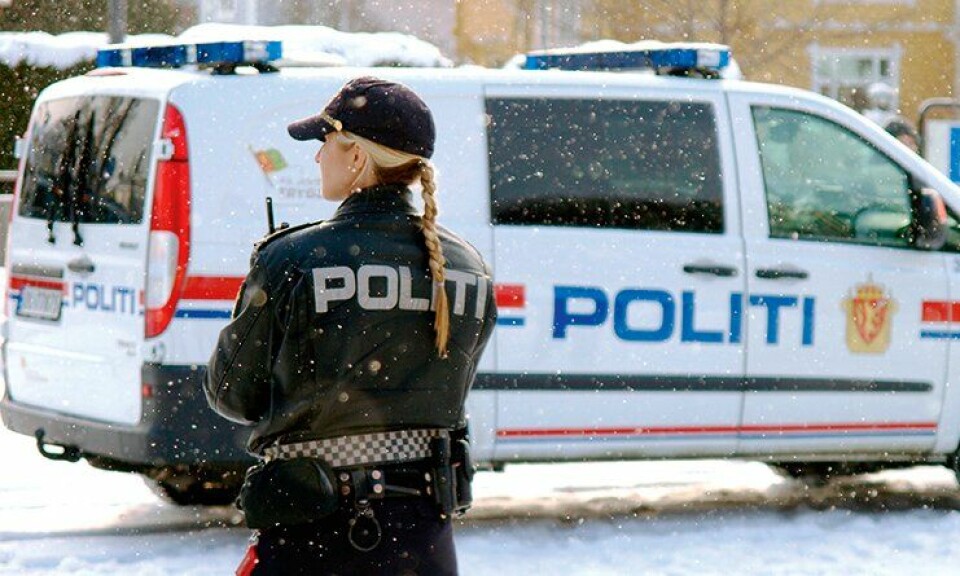 Politikvinne og politibil, vinter.