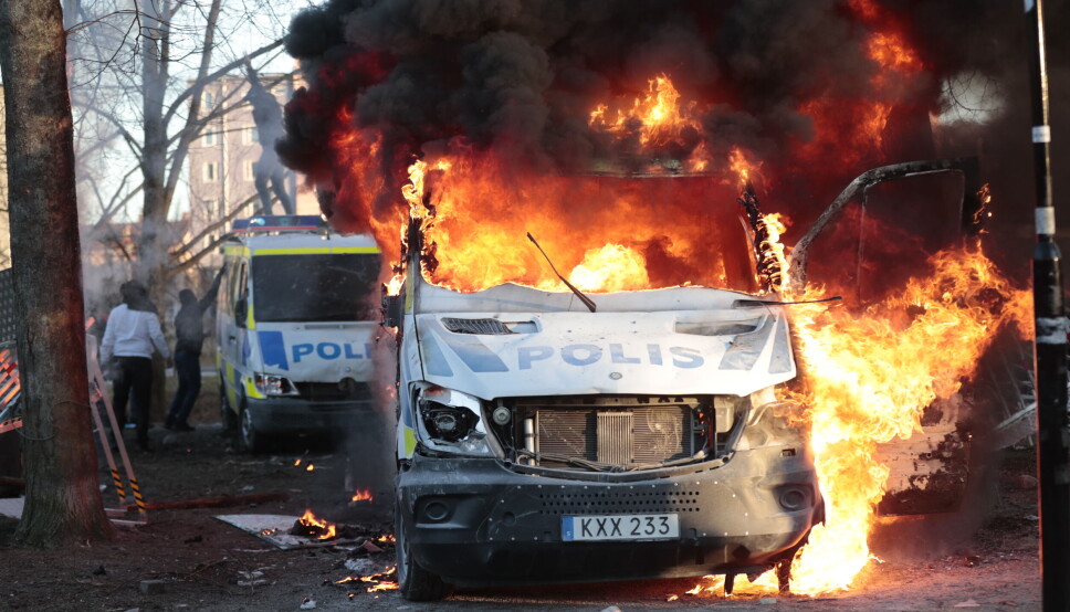 Motdemonstrantene satte fyr på politibiler. Disse ble totalskadd.
